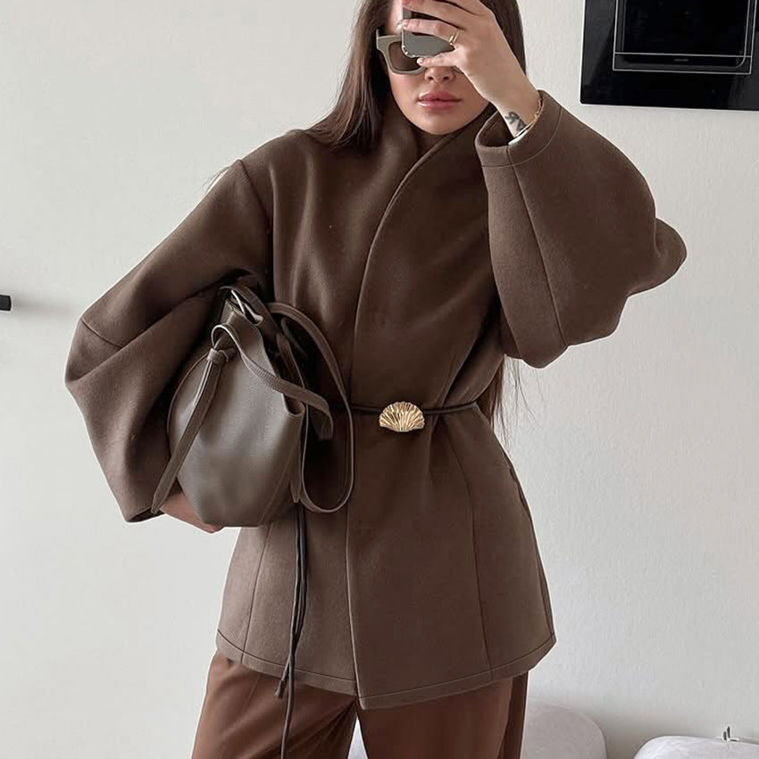 This high-end brown cinched-waist woolen coat for women in autumn and winter exudes a stylish and elegant design