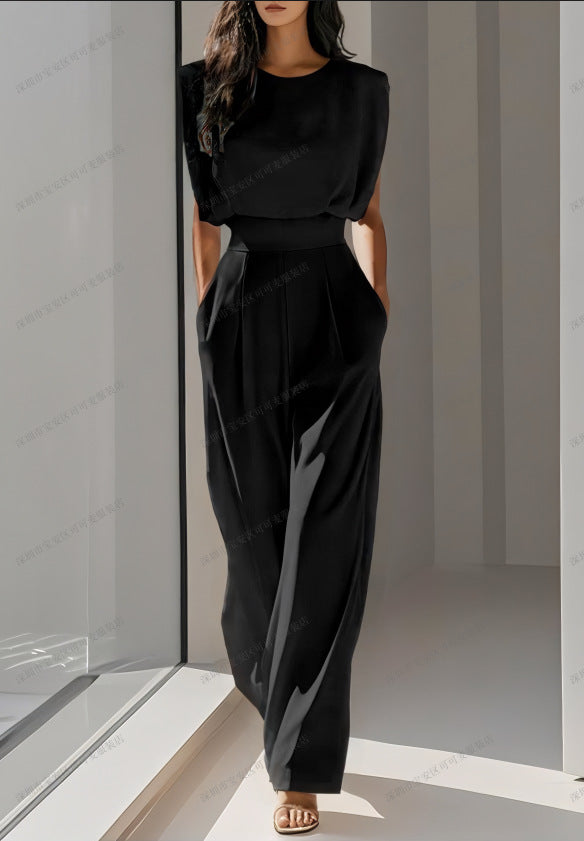A solid color waist-cinching and slimming jumpsuit with a sophisticated and elegant feminine style